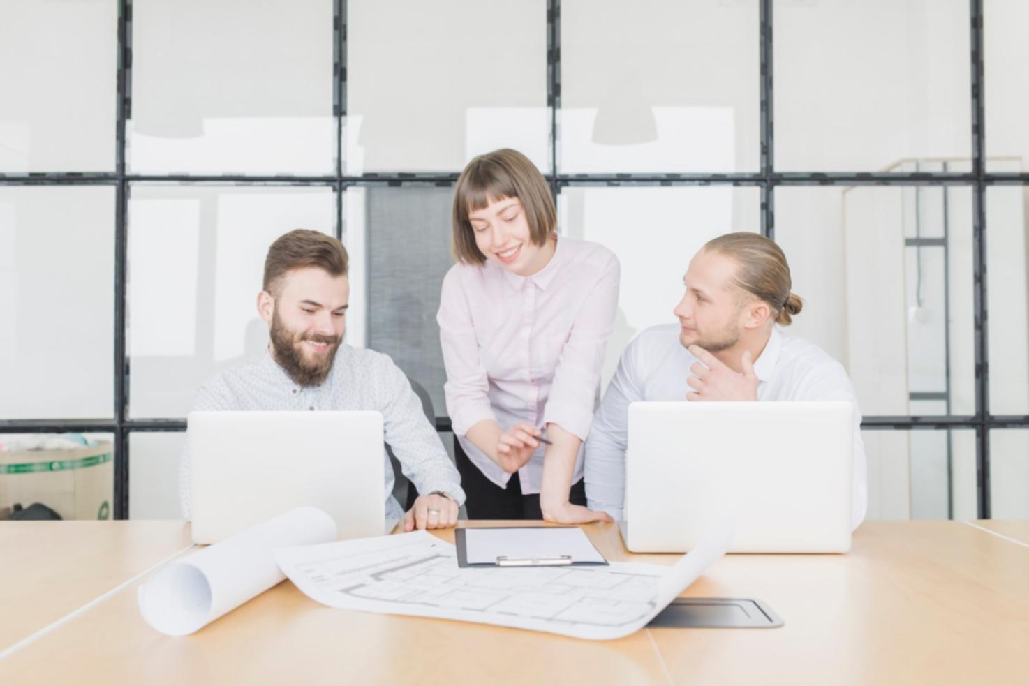 Professional woman reviewing business documents and financial reports during strategic planning session